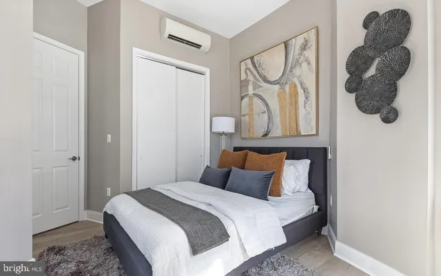 a bedroom with a bed and a painting on the wall