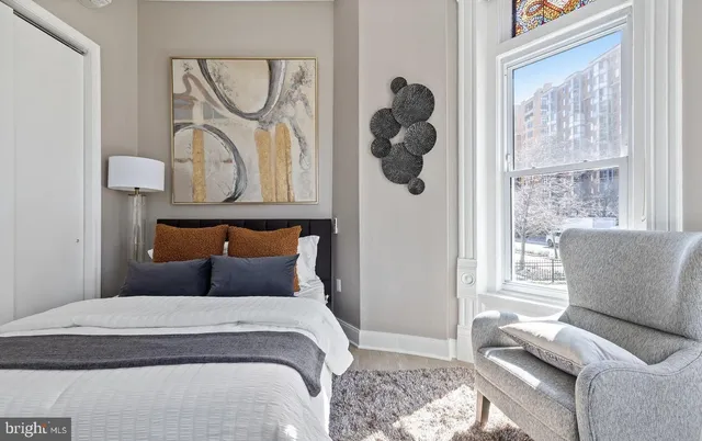 a bedroom with furniture and a window