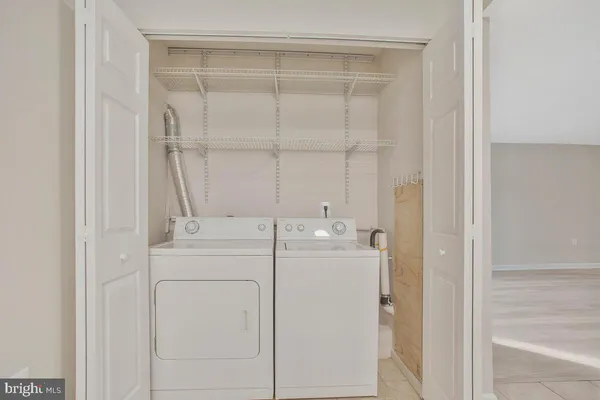 a utility room with closet dryer and washer