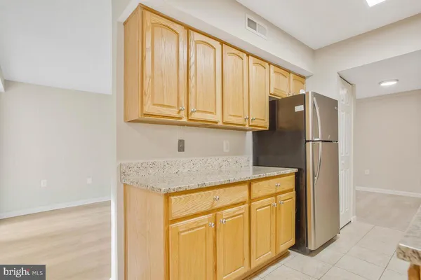 a kitchen with stainless steel appliances granite countertop a refrigerator and cabinets
