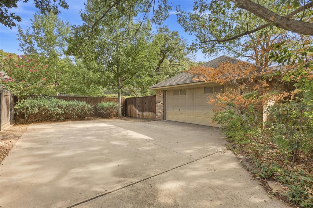 37 Timbergreen Circle Denton, TX 76205 - Photo 5 of 31 Concrete driveway leading to an attached garage with a panel door