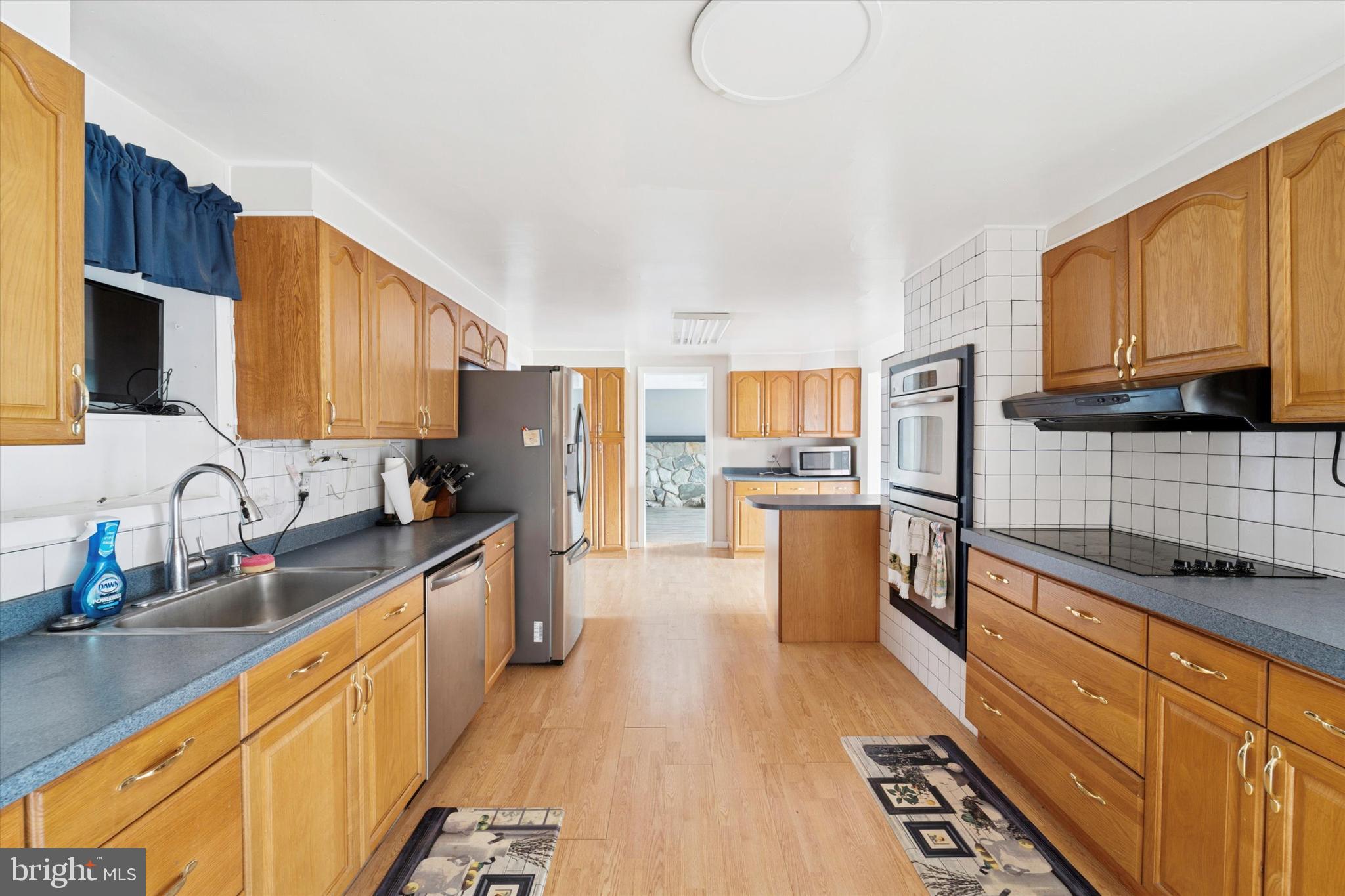 3418 Mill Road Collegeville, PA 19426 - Photo 9 of 35 a large kitchen with stainless steel appliances granite countertop a stove a sink dishwasher and a refrigerator