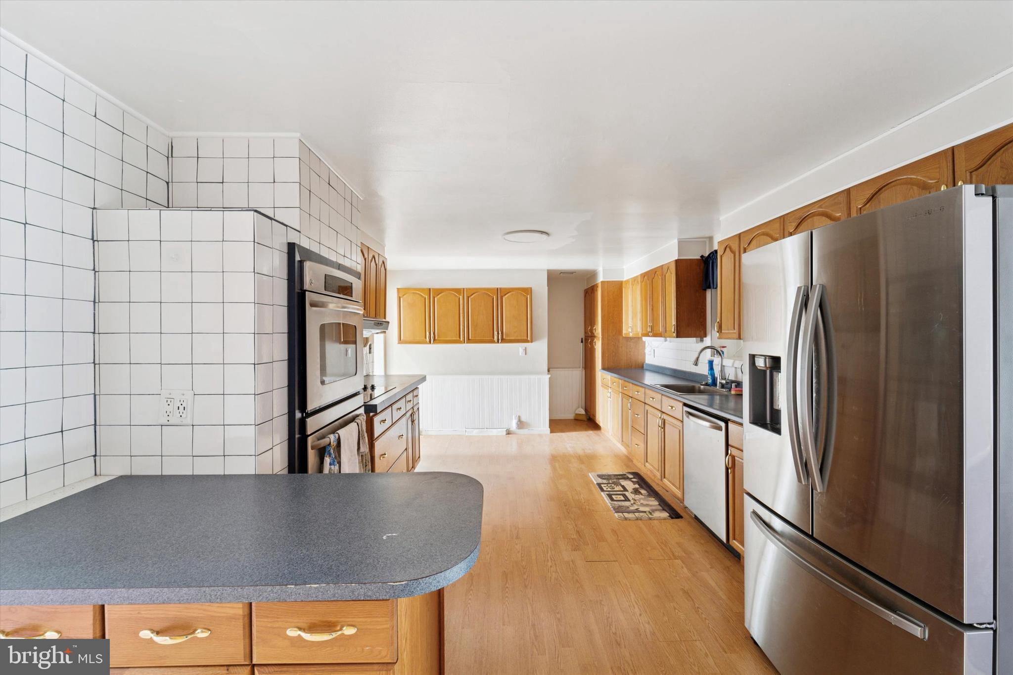 3418 Mill Road Collegeville, PA 19426 - Photo 10 of 35 a kitchen with stainless steel appliances granite countertop a refrigerator a stove and a sink
