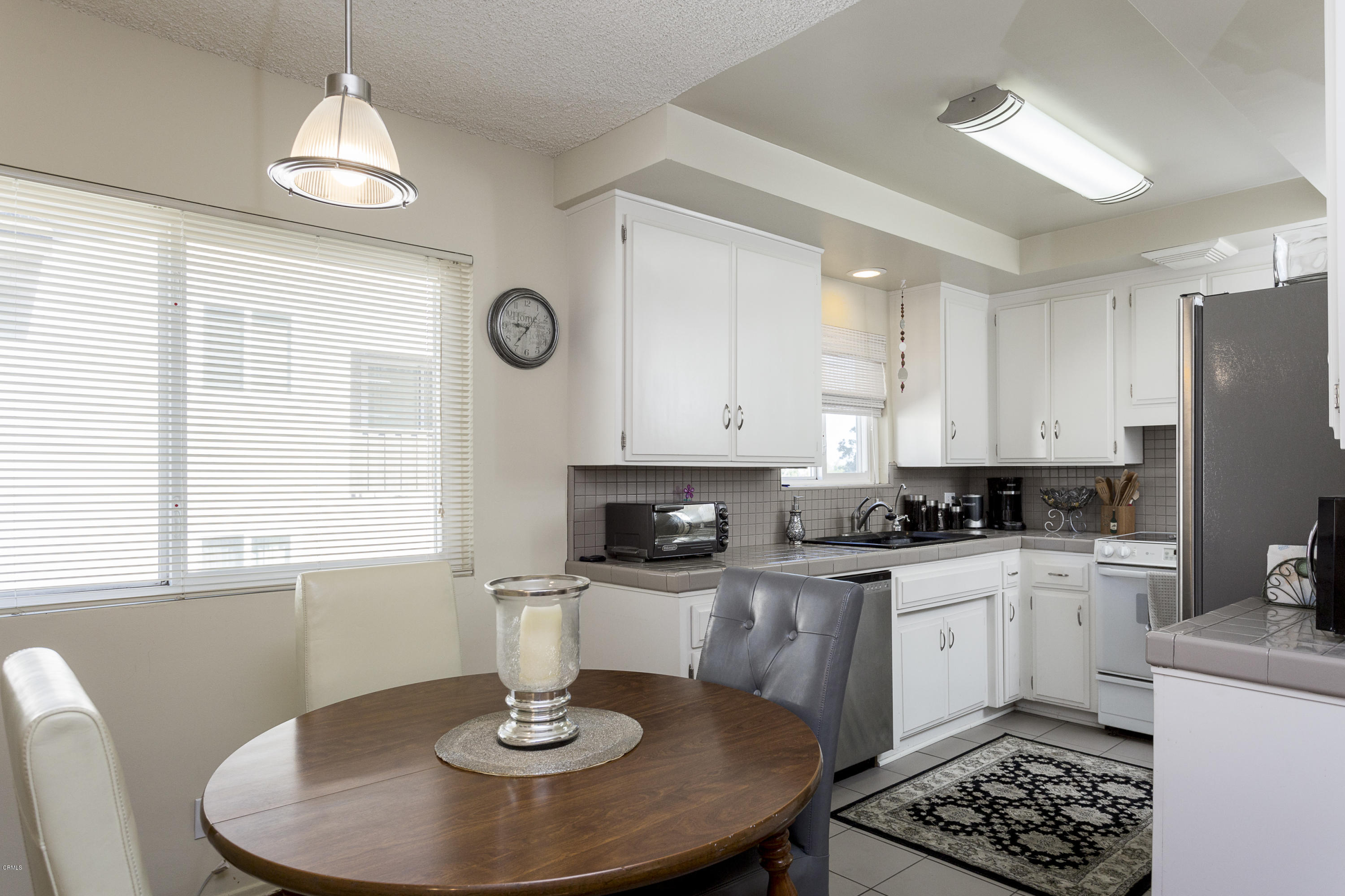 385 Cliff Drive, Unit 3 Pasadena, CA 91107 - Photo 5 of 13 a kitchen with granite countertop a stove a sink and a refrigerator