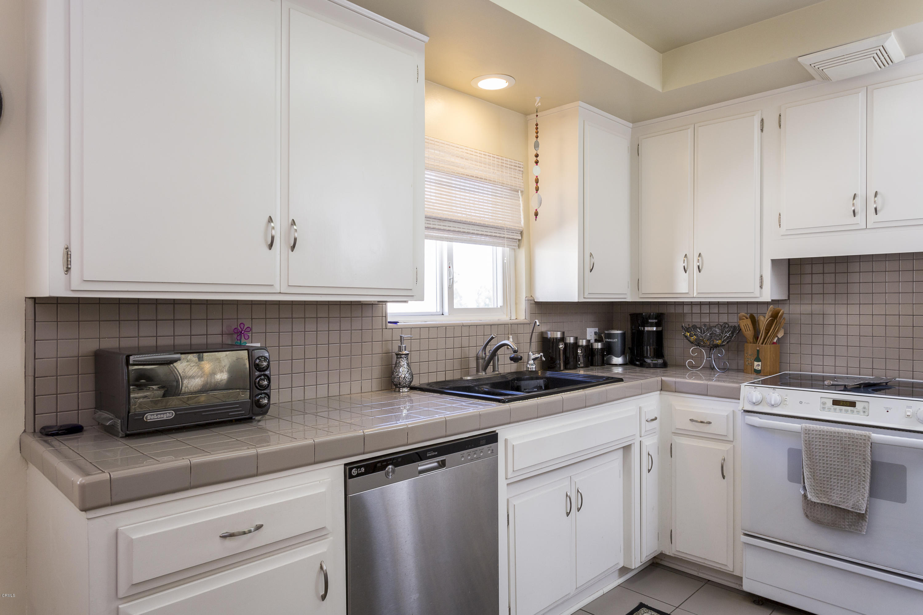 385 Cliff Drive, Unit 3 Pasadena, CA 91107 - Photo 6 of 13 a kitchen with white cabinets and white appliances