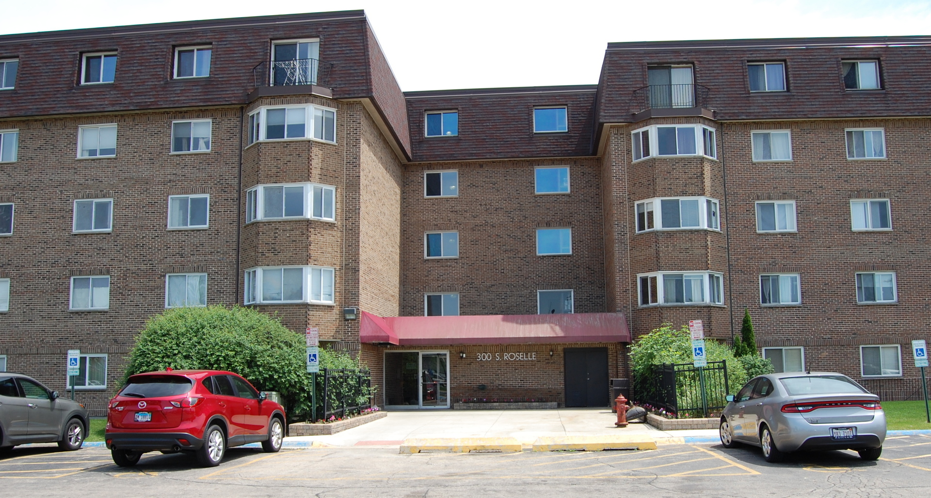300 South Roselle Road, Unit 507 Schaumburg, IL 60193 - Photo 2 of 19 a car parked in front of a brick building