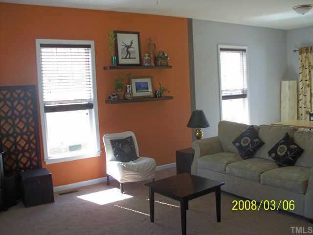 217 Cooke Street Raleigh, NC 27601 - Photo 2 of 12 Bright, open living room with custom paint, carpet and window treatments is large enough for any size furniture! Ceiling Fan and upgraded light fixtures. Great space for entertaining! Other