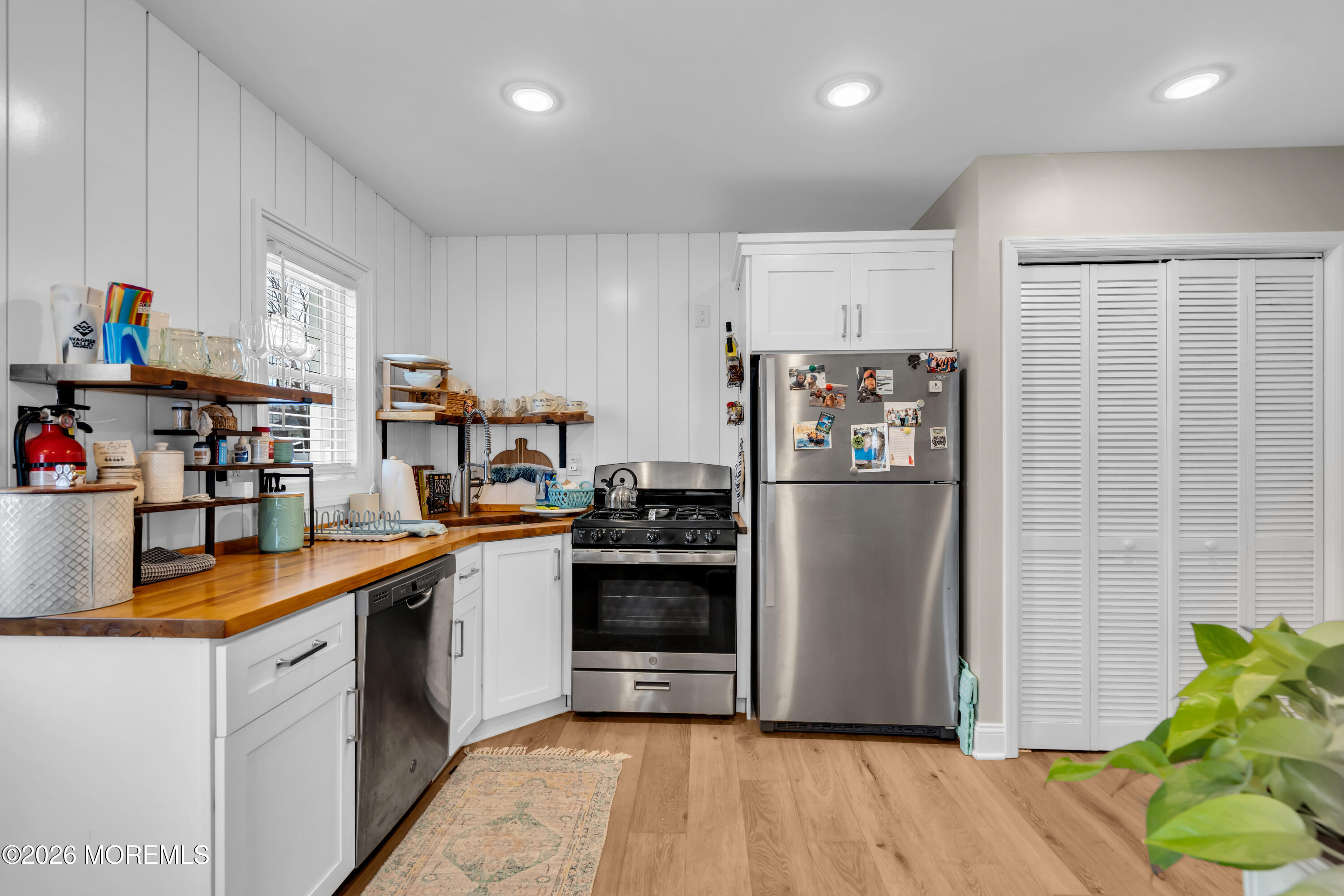 1215 Lister Street, Unit B Point Pleasant, NJ 08742 - Photo 9 of 16 a kitchen with stainless steel appliances granite countertop a refrigerator and a stove