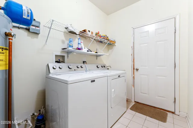 a utility room with cabinets washer and dryer