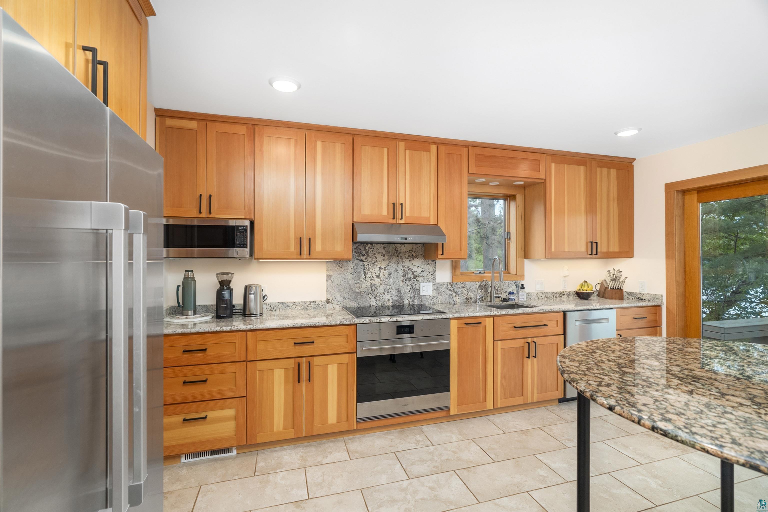 5791 South Pike Lake Road Duluth, MN 55811 - Photo 10 of 50 Kitchen features a Wolf range, and Fisher Paykel refrigerator and dishwasher