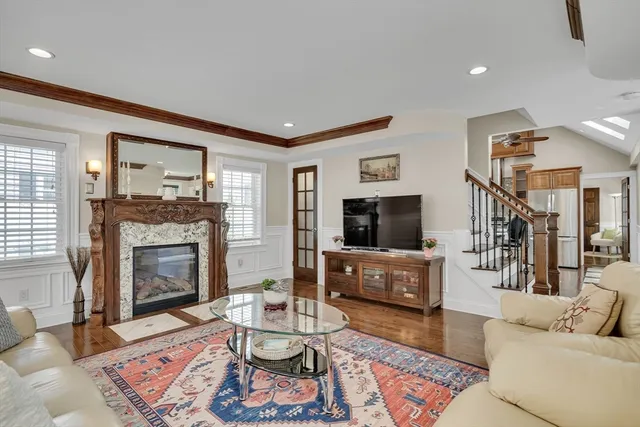 a living room with furniture a flat screen tv and a fireplace