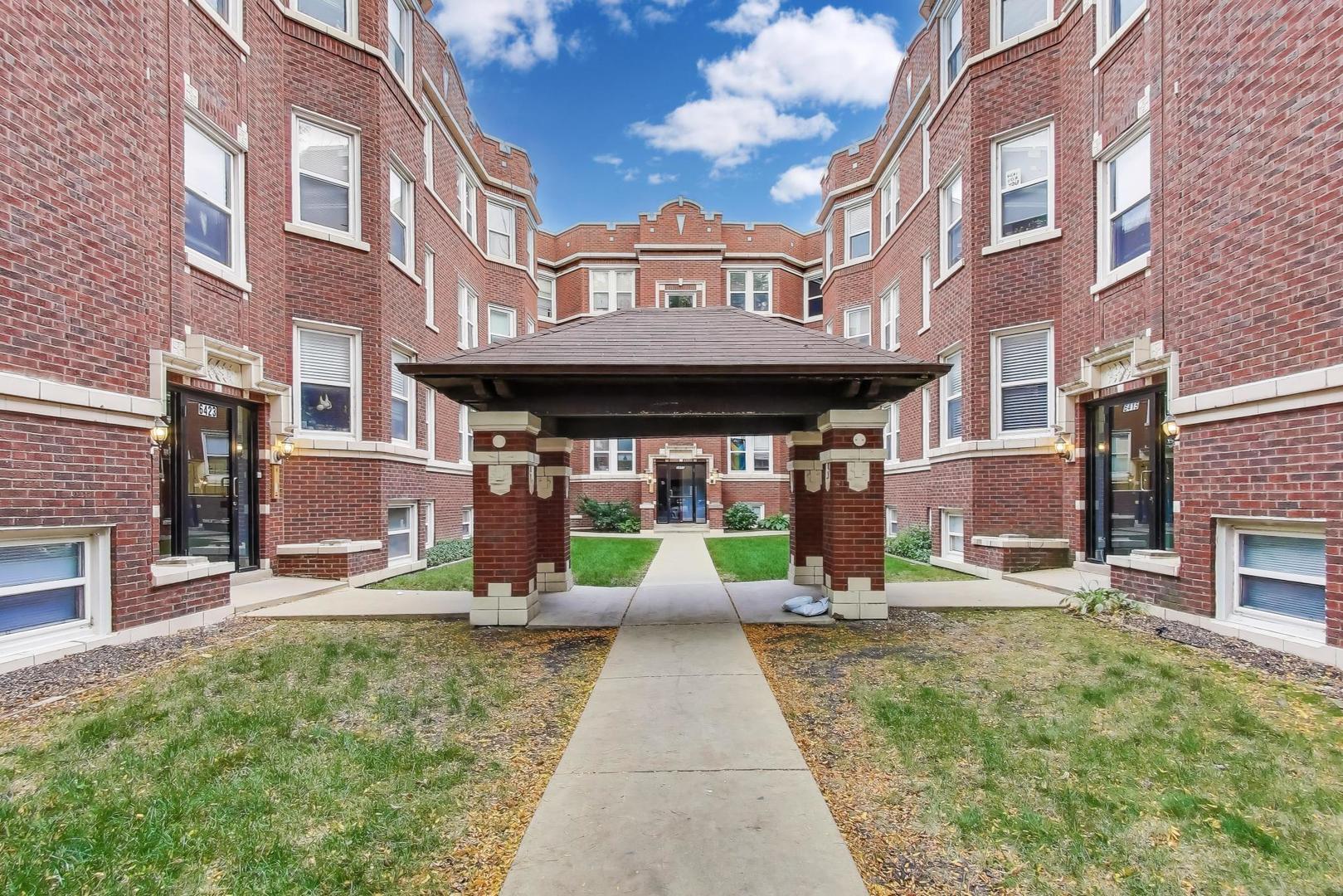 6421 North Greenview Avenue, Unit 2W Chicago, IL 60626 - Photo 21 of 23 a front view of a brick building with a yard