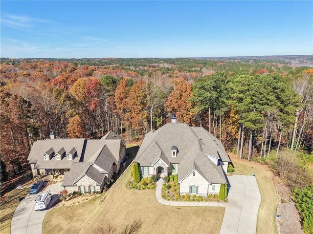an aerial view of a house with a swimming pool