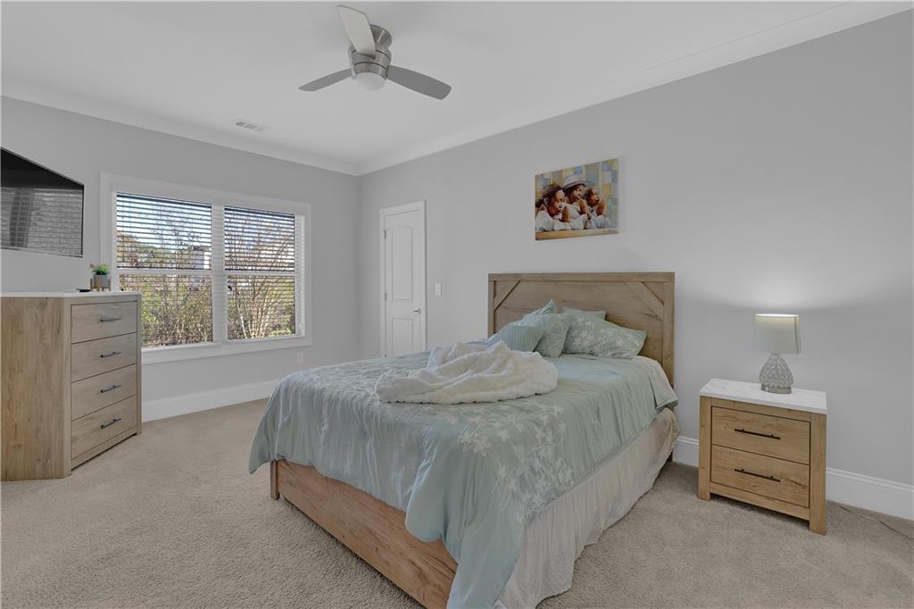 1560 Tapestry Ridge Southeast Lawrenceville, GA 30045 - Photo 37 of 61 a spacious bedroom with a bed and a window