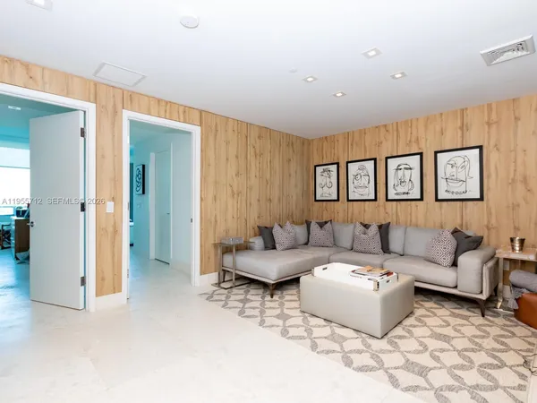 a living room with furniture and painting on the wall