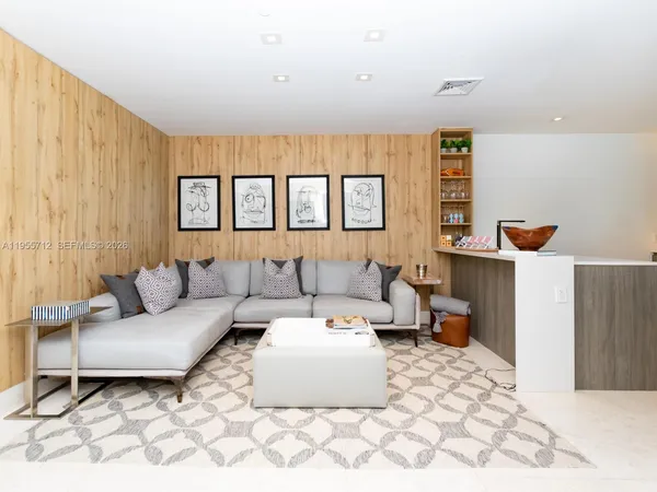 a bedroom with a bed a flat screen tv and a large window with the outer view