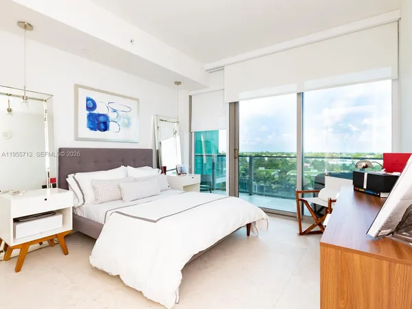 a bedroom with a bed and a painting on the wall