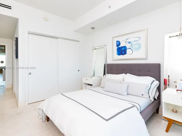 a bedroom with a bed and a couch