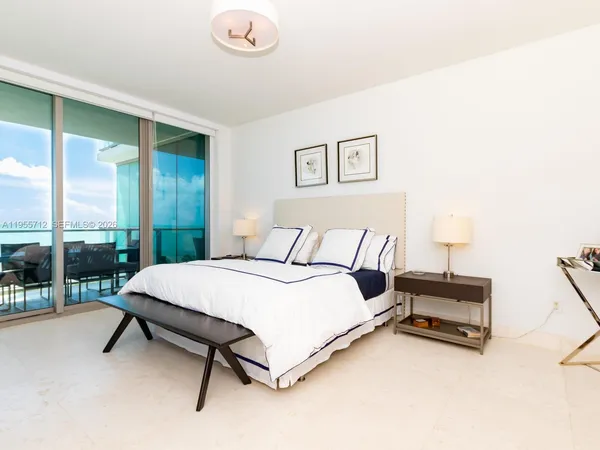 a spacious bedroom with a bed and a chair