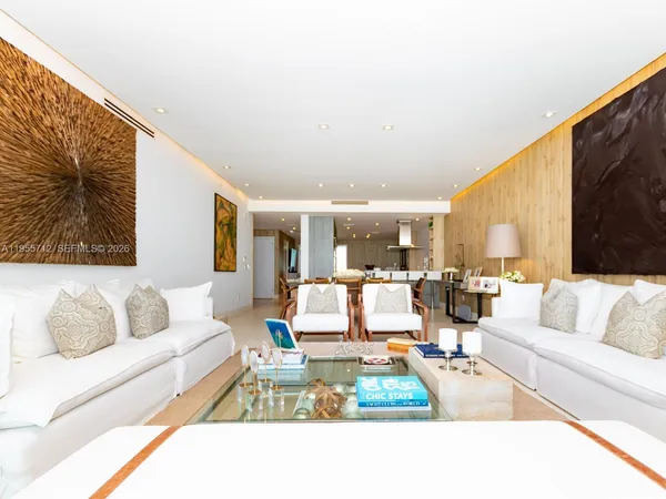 a dining hall with stainless steel appliances kitchen island granite countertop a dining table and chairs