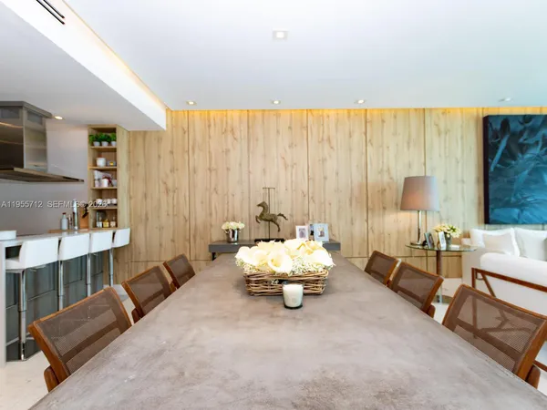 a kitchen with a stove a refrigerator and a dining table
