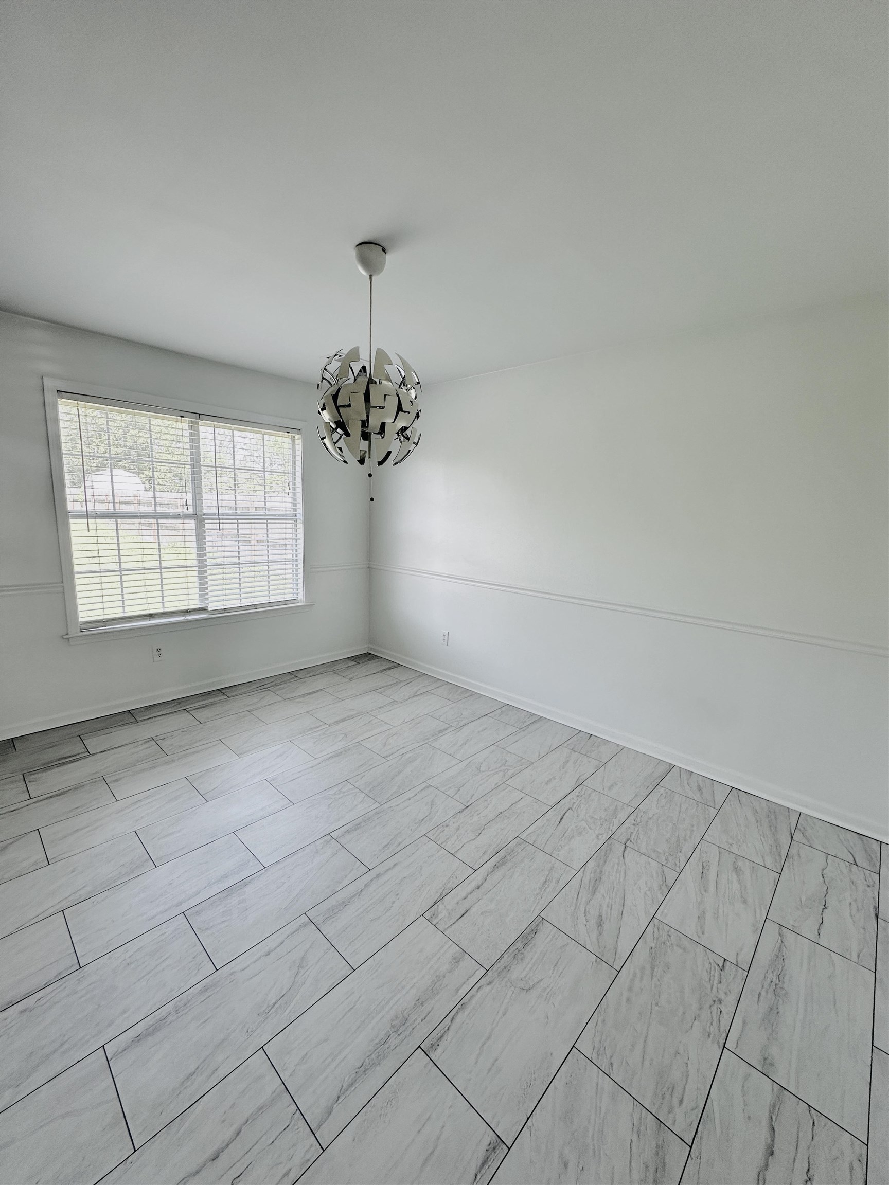 10006 Cameron Ridge Trail Memphis, TN 38016 - Photo 5 of 29 an empty room with chandelier fan and windows