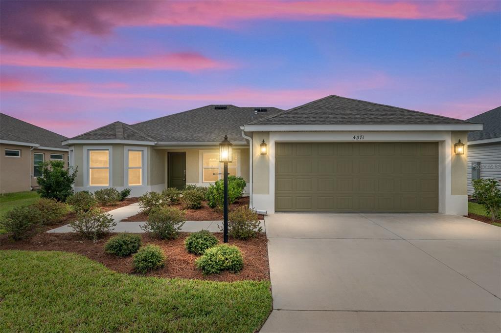 4371 Shannon Loop The Villages, FL 32163 - Photo 1 of 1 a front view of a house with garden