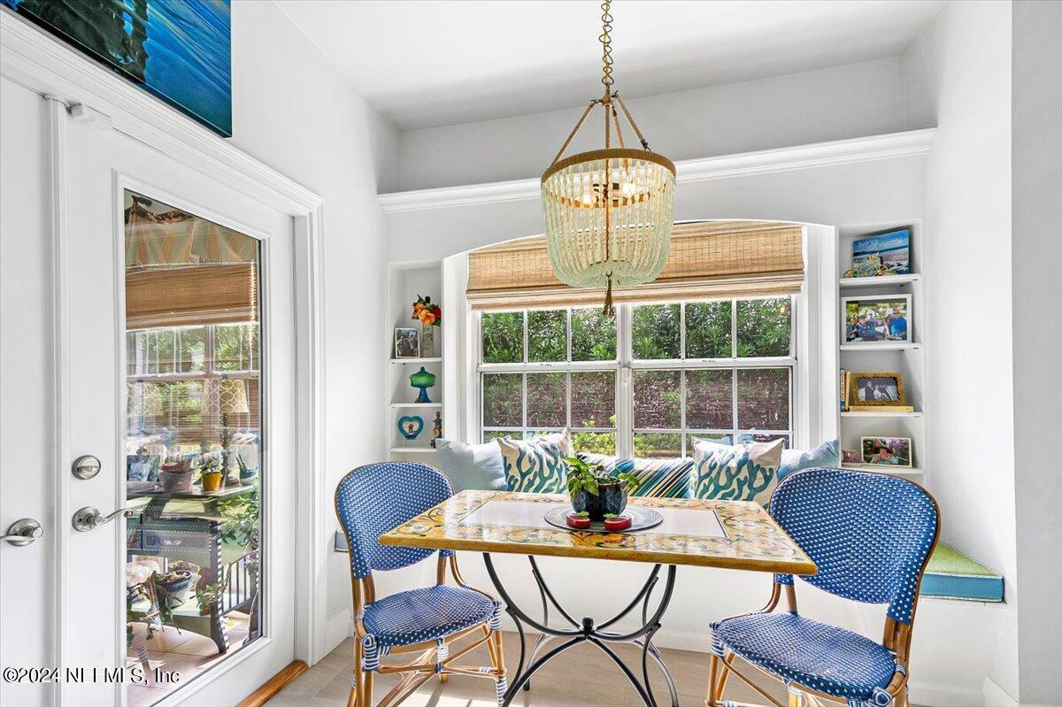 4295 Heath Road Jacksonville, FL 32277 - Photo 14 of 64 a view of a dining room with furniture wooden floor and chandelier