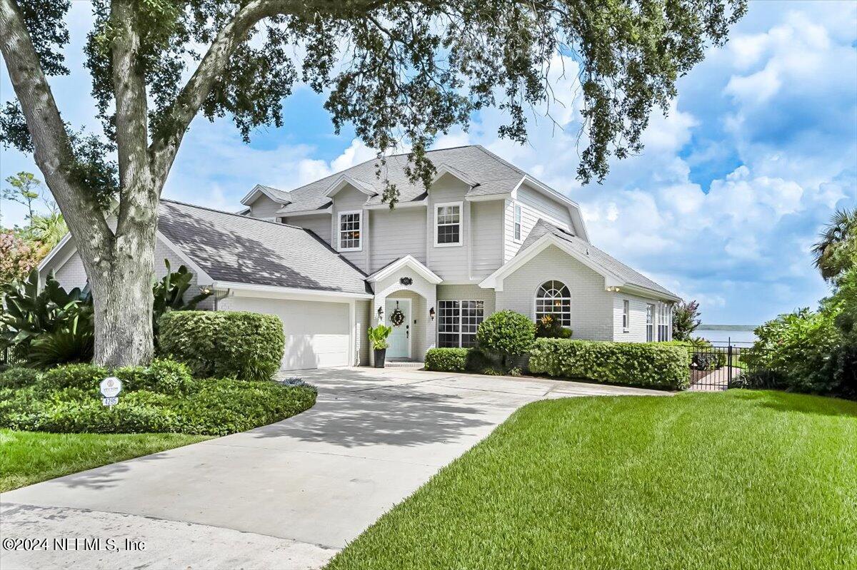 4295 Heath Road Jacksonville, FL 32277 - Photo 2 of 64 a front view of a house with a yard and garage