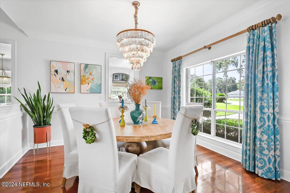 4295 Heath Road Jacksonville, FL 32277 - Photo 32 of 64 a view of a dining room with furniture a chandelier and wooden floor