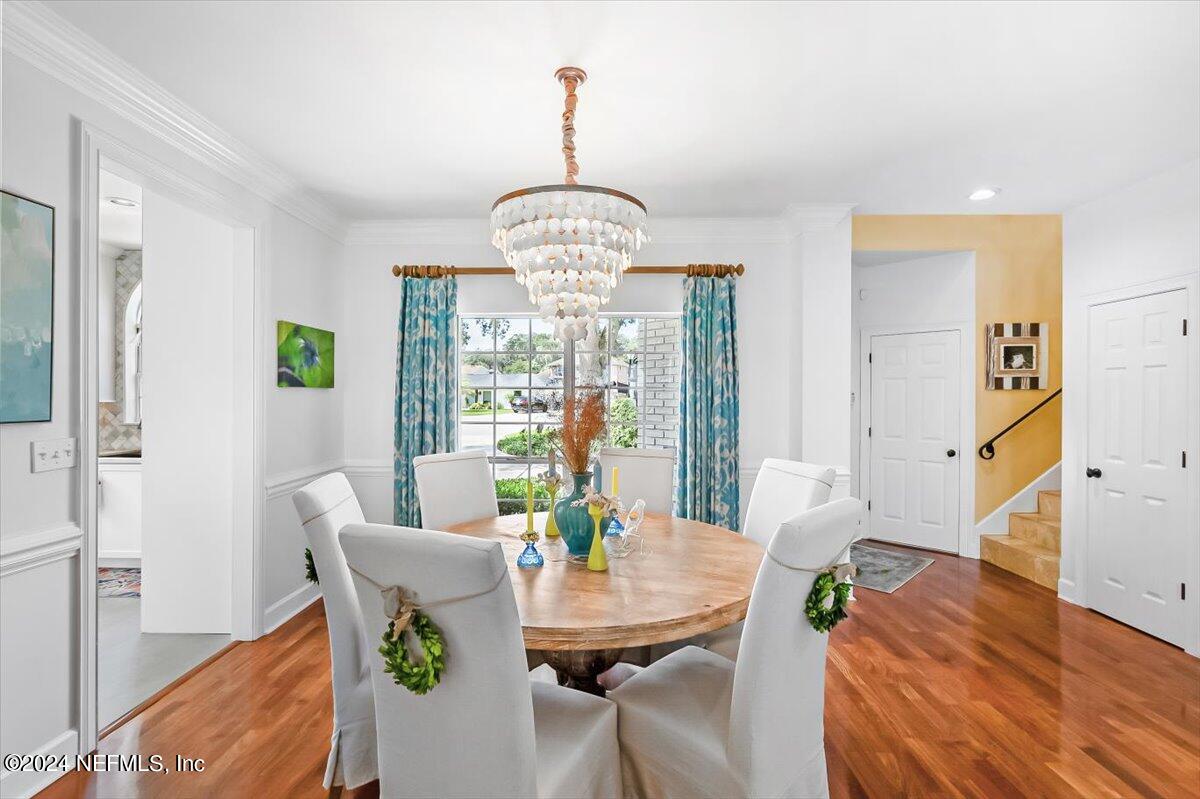 4295 Heath Road Jacksonville, FL 32277 - Photo 33 of 64 a view of a dining room with furniture a chandelier and wooden floor