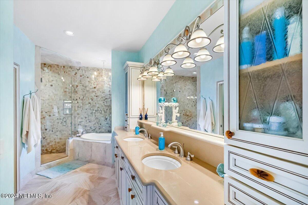 4295 Heath Road Jacksonville, FL 32277 - Photo 39 of 64 a bathroom with a granite countertop sink mirror vanity and bathtub