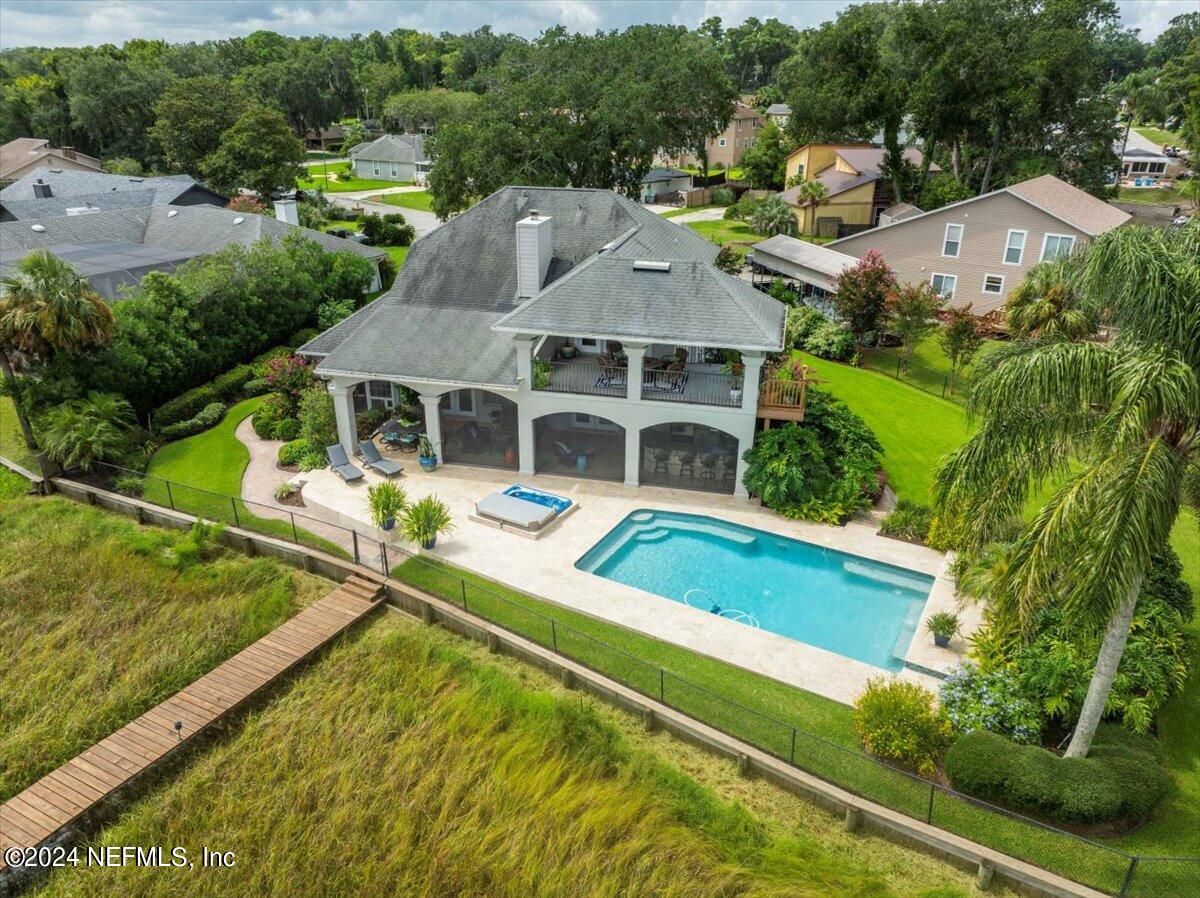 4295 Heath Road Jacksonville, FL 32277 - Photo 4 of 64 an aerial view of a house with swimming pool and large trees