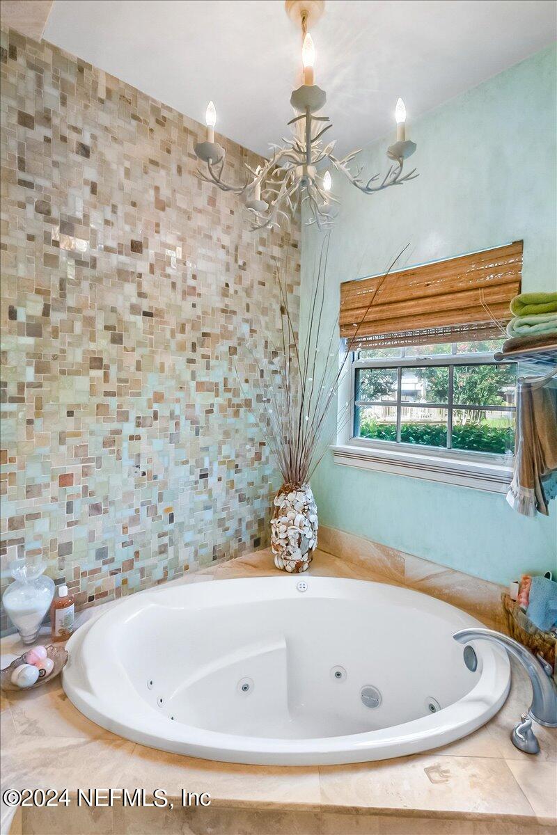 4295 Heath Road Jacksonville, FL 32277 - Photo 41 of 64 a bathroom with a tub and a shower