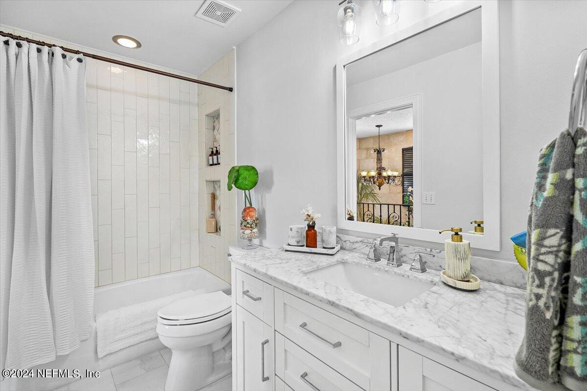 4295 Heath Road Jacksonville, FL 32277 - Photo 49 of 64 a bathroom with a granite countertop sink toilet and shower