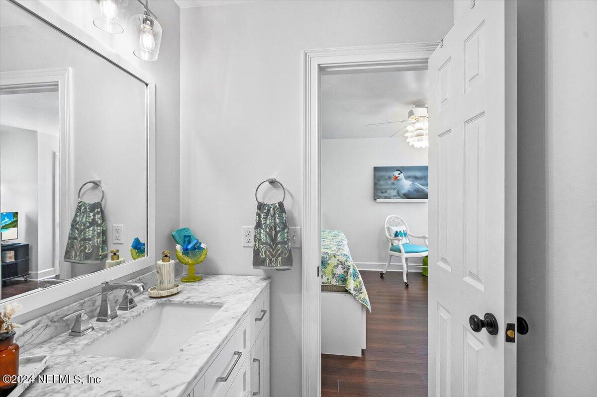 4295 Heath Road Jacksonville, FL 32277 - Photo 50 of 64 a bathroom with a granite countertop sink a bathtub and a window
