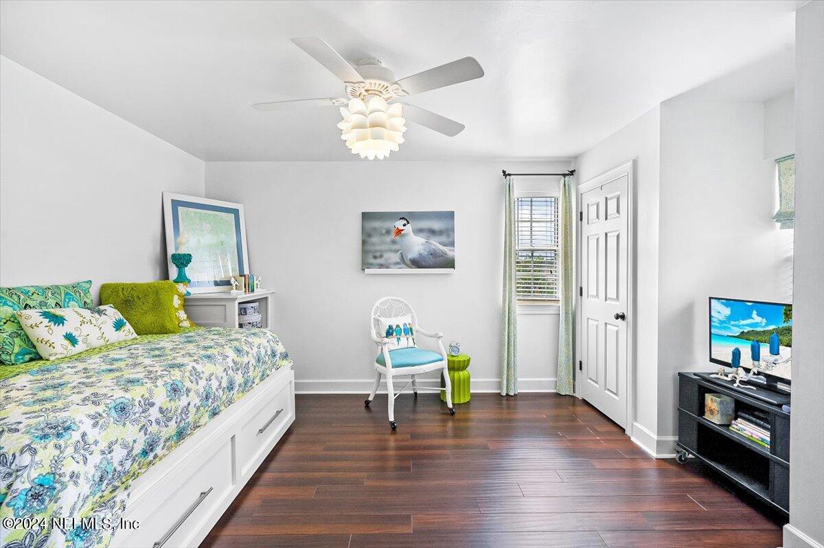 4295 Heath Road Jacksonville, FL 32277 - Photo 51 of 64 a bedroom with a bed and a wooden floor