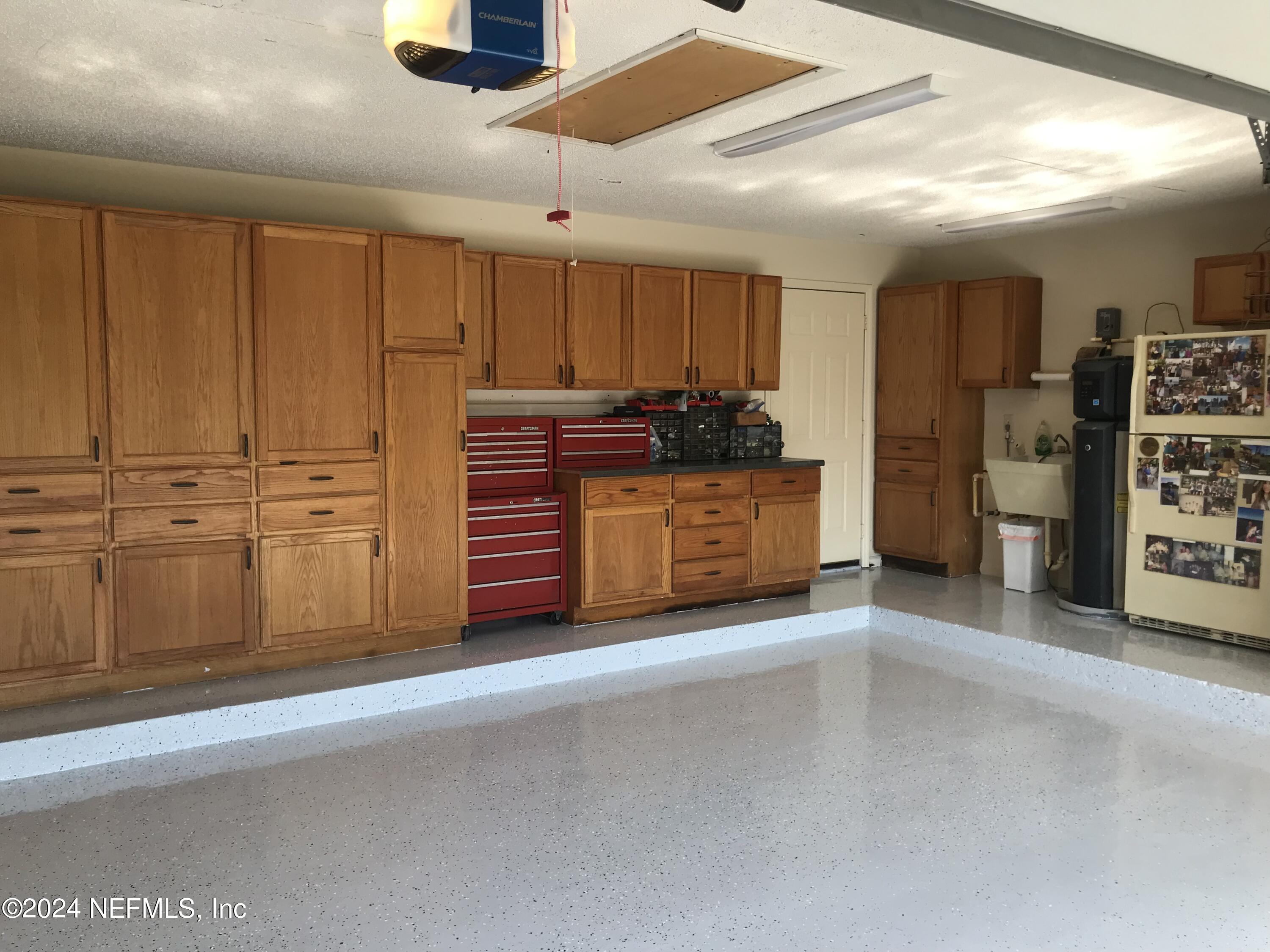 4295 Heath Road Jacksonville, FL 32277 - Photo 63 of 64 a view of a livingroom with an empty space and a kitchen