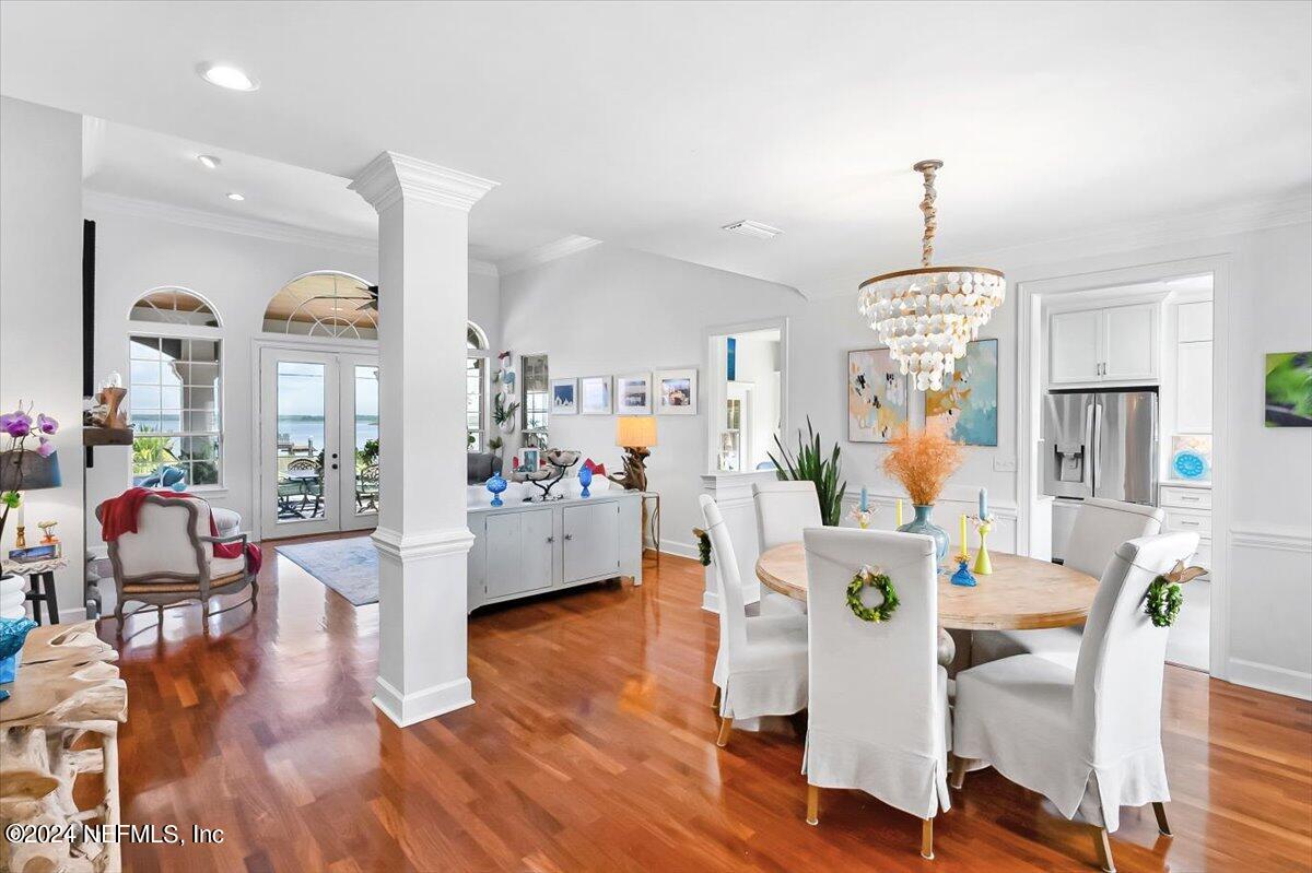 4295 Heath Road Jacksonville, FL 32277 - Photo 8 of 64 a view of a dining room and livingroom with furniture wooden floor a chandelier