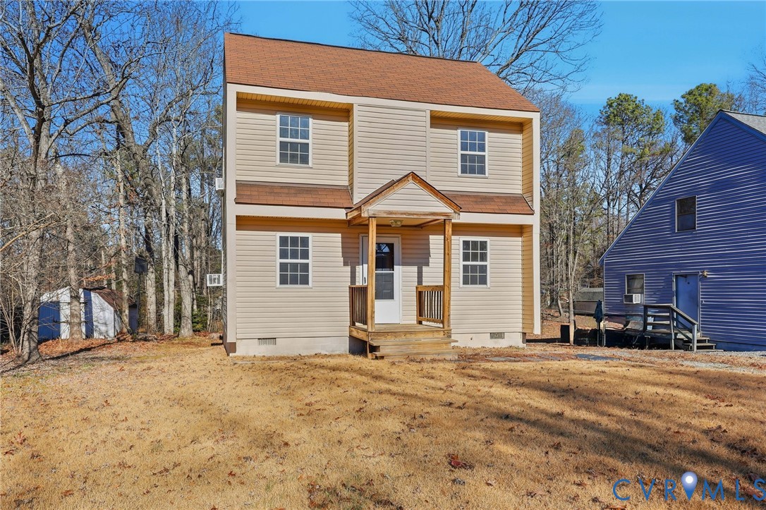 View of front of home with crawl space and roof wi