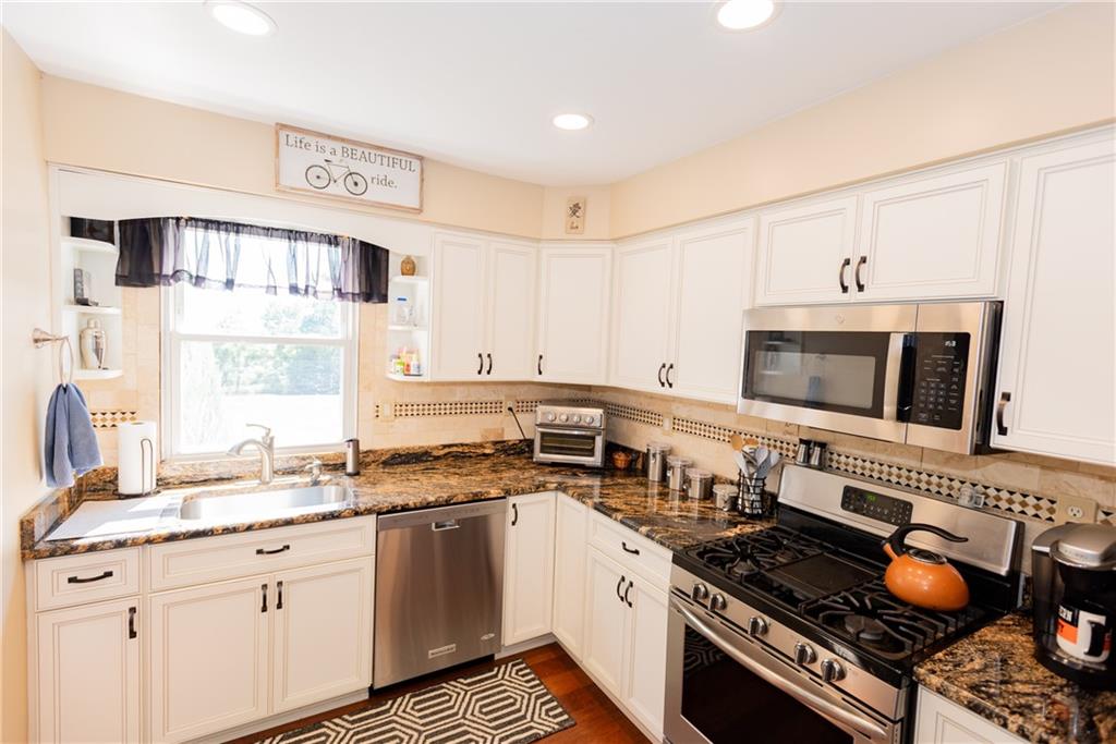 2011 Scheffel Road Pittsburgh, PA 15237 - Photo 8 of 29 a kitchen with stainless steel appliances a stove a sink and a microwave