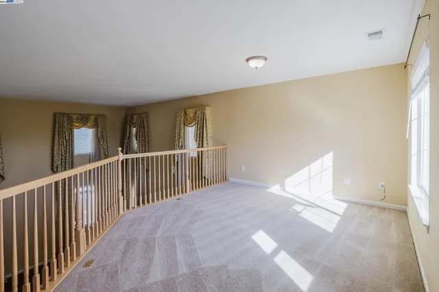 a view of a hallway with wooden floor and closet