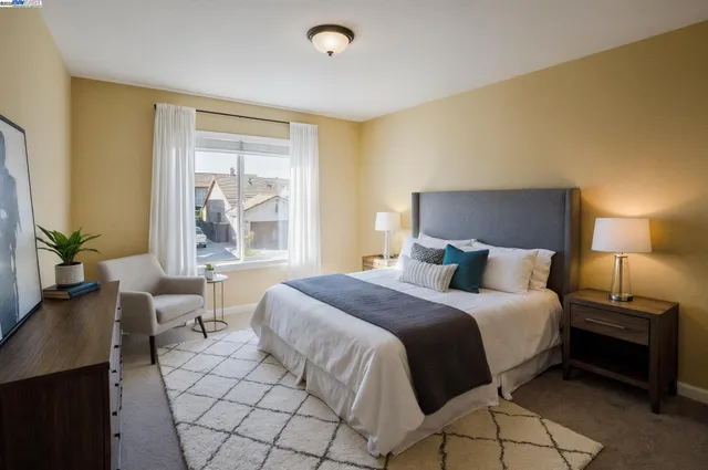 a bedroom with a bed and a window