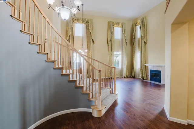 a view of entryway with wooden floor and stairs