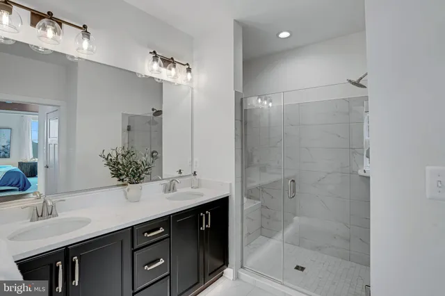 a bathroom with a sink double vanity and shower