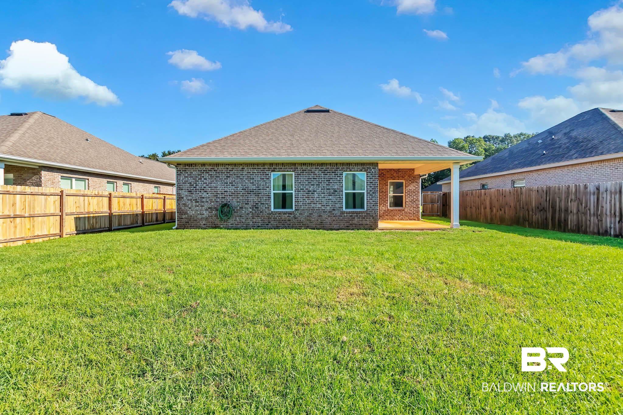 16461 Prado Loop Loxley, AL 36551 - Photo 58 of 78 Rear view of property featuring a patio, brick siding, a fenced backyard, and a shingled roof