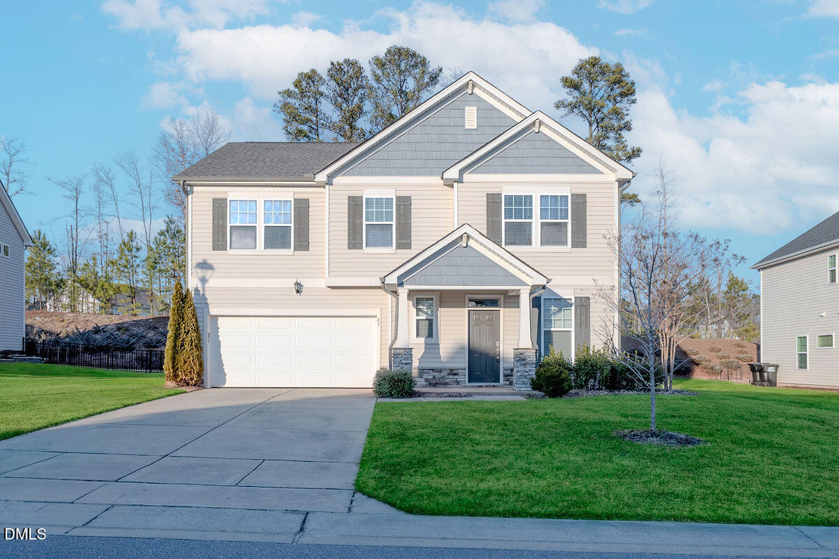 87 East Ravano Drive Clayton, NC 27527 - Photo 1 of 37 a front view of a house with a yard