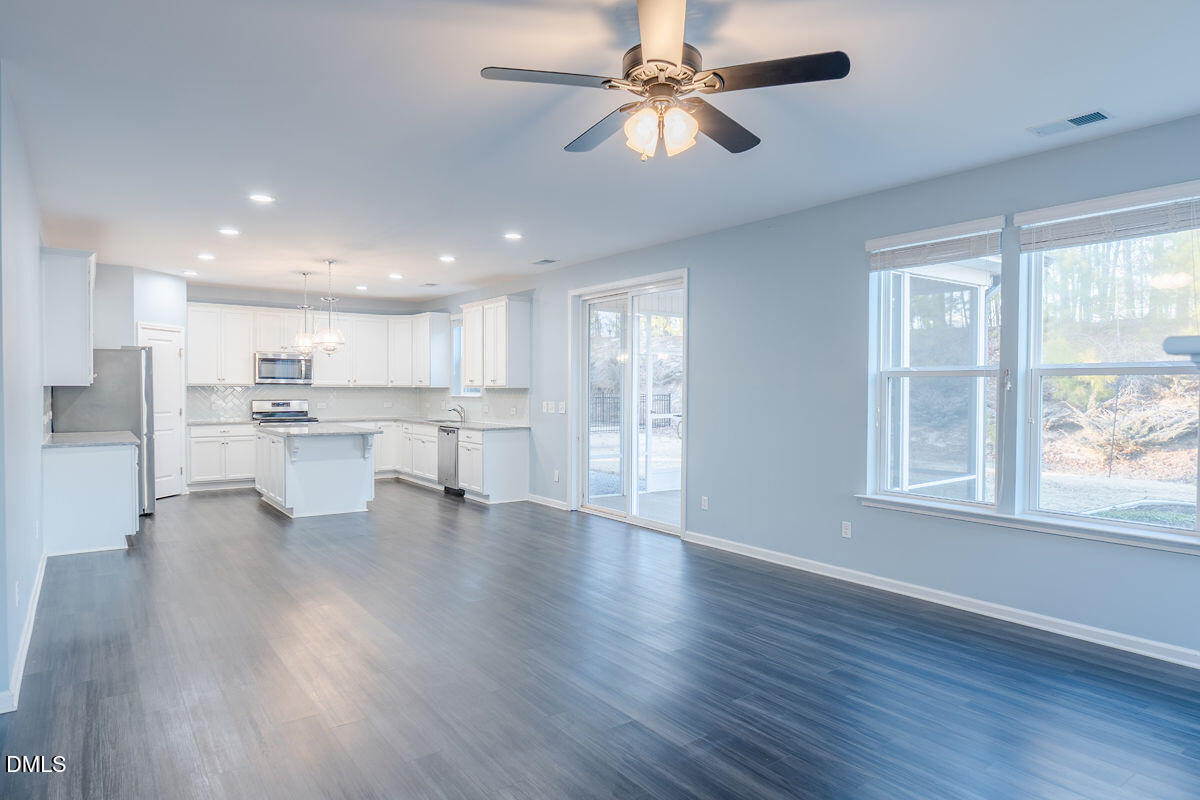 87 East Ravano Drive Clayton, NC 27527 - Photo 12 of 37 a view of an empty room with wooden floor and a window