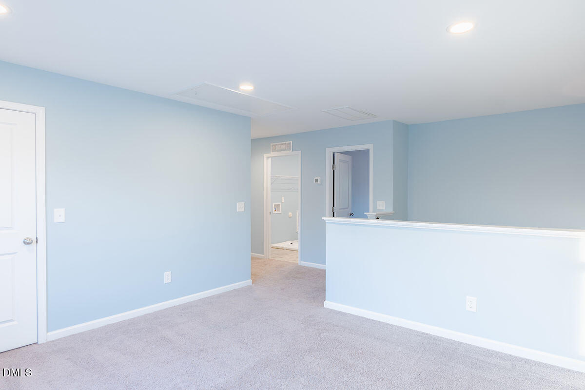 87 East Ravano Drive Clayton, NC 27527 - Photo 18 of 37 a view of an empty room