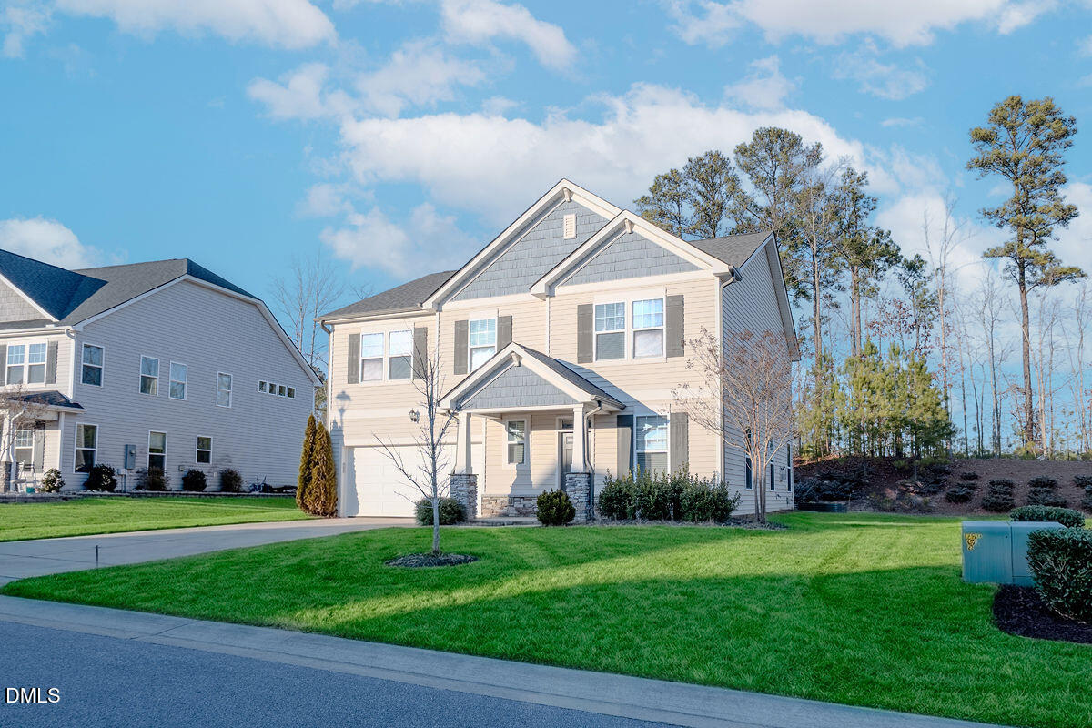 87 East Ravano Drive Clayton, NC 27527 - Photo 2 of 37 a front view of a house with a garden